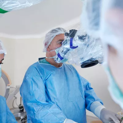 A doctor using a machine to assist in surgery