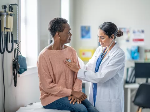 A Doctor Check's Her Patient Breathing with a Stethoscope