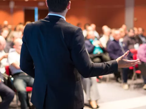 Man giving a lecture to a rapt audience.