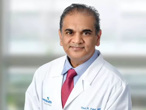 A professional portrait shot of Doctor Patel