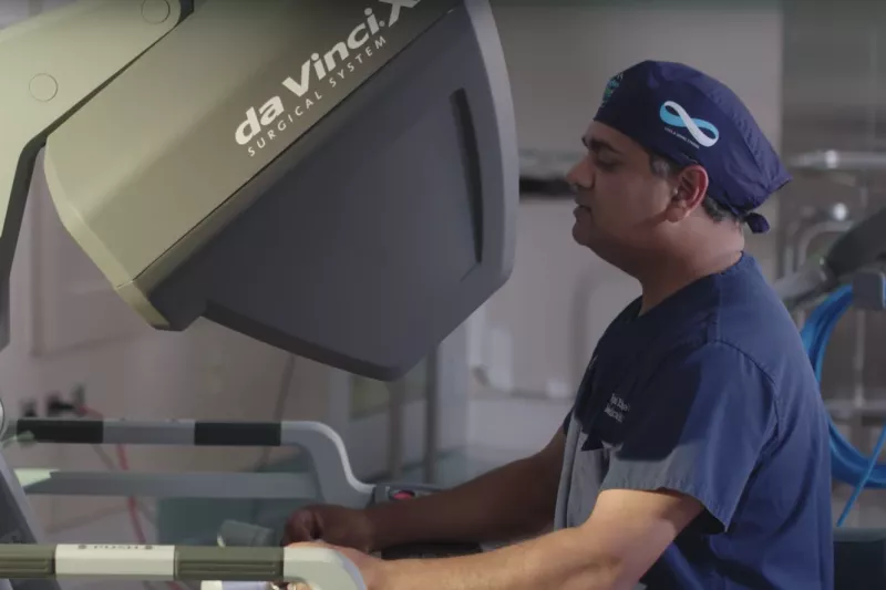 Dr Vipul Patel operating the Da Vinci Robot